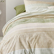 closer view: Close-up of Shitake green duvet cover showing patterned horizontal bands in green, beige and cream