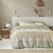full bed: Shitake cotton duvet cover with green, beige and cream horizontal bands, styled on a bed with matching pillows