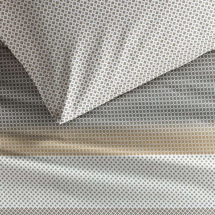 fabric detail: Strom cotton duvet cover and matching pillowcase showing small geometric motifs and contrasting patterned bands