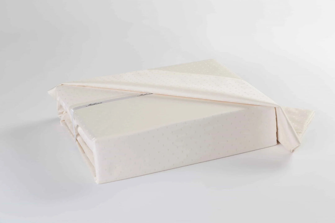 Athena 400 Thread Count Swiss Dots Duvet Cover Set in white with textured dot pattern on bed