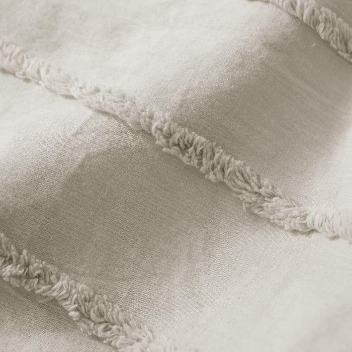 fabric detail: Cotton duvet cover fabric detail showing raised tufted stripes on a smooth light neutral background