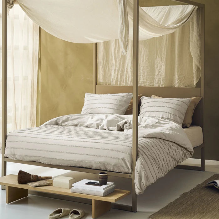full bed: Tufted cotton duvet cover with raised horizontal stripes in a light neutral shade, styled on a canopy bed