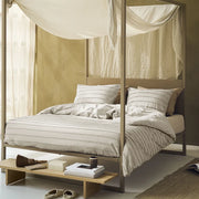full bed: Tufted cotton duvet cover with raised horizontal stripes in a light neutral shade, styled on a canopy bed