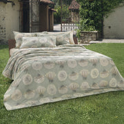 Tara dandelion print duvet cover and shams styled on a bed outdoors in a garden setting – 100% long-staple cotton by Cuddle Down
