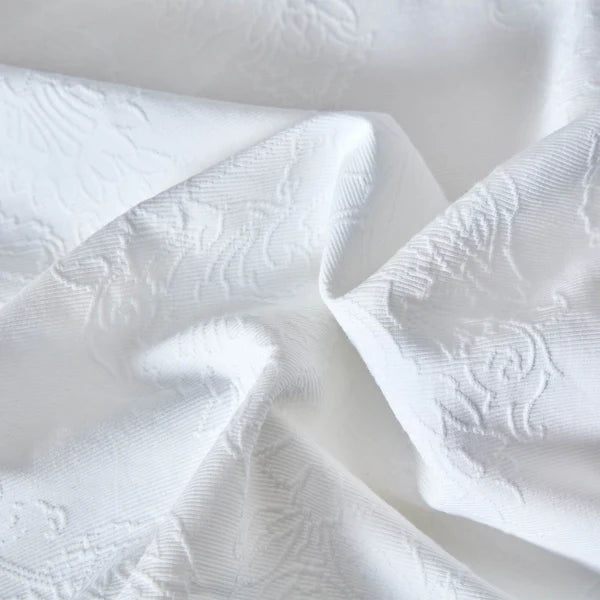 Close-up of Bianca duvet cover medallion texture showing detailed woven pattern and rich matelassé finish