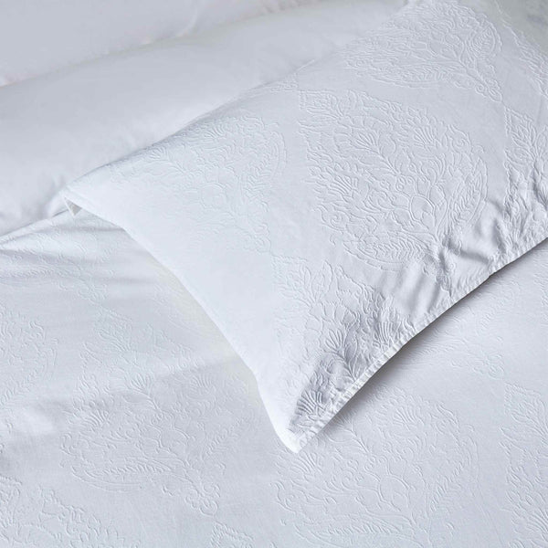Bianca duvet cover set styled on a bed showcasing the timeless white medallion design and sophisticated bedroom elegance