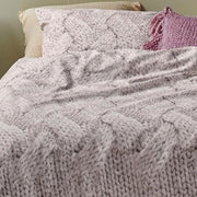 Close-up of Tricot duvet cover showing detailed knit pattern in ivory and taupe on cotton fabric