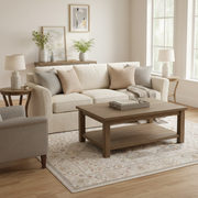 Cubana Polyester Powerloomed Rug CUB-1504 styled in a family room under a coffee table and sofa — cream and beige Persian medallion design