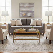 Traditional Persian floral botanical area rug in cream and charcoal grey styled in a family room with a grey sofa and gold coffee table — elegant neutral design