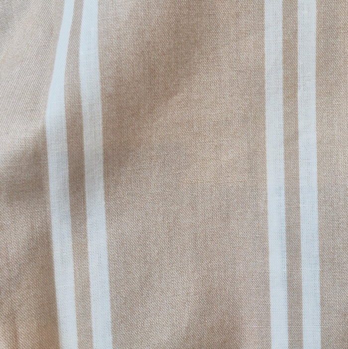 Close-up of martini olive and natural stripe pattern on 100% cotton duvet cover