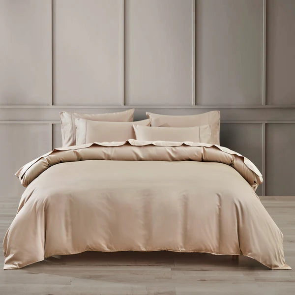 Beige bed skirt set on a bed against a gray paneled wall