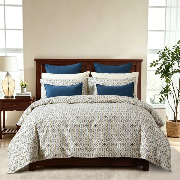 Motif duvet cover set with a blue and green block print on ivory and matching pillowcases styled on a bed.
