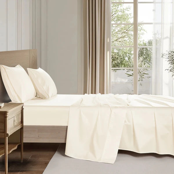 Close-up of organic cotton sheet set showing soft natural fabric weave and fine texture