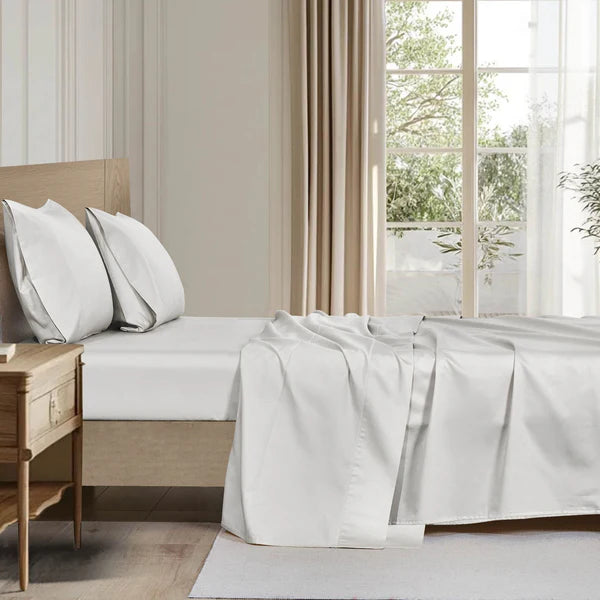 Organic cotton sheet set styled on a bed with white pillows, pure and eco-friendly bedding