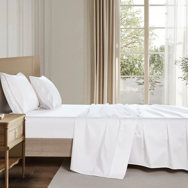 Organic cotton sheet set on a styled bed, soft breathable and naturally hypoallergenic