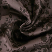 Close-up of Sepia Shadow fabric showing dark brown floral silhouettes on a warm brown background.
