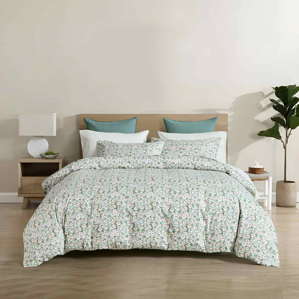 Teryn floral duvet cover set in green, aqua and olive with white blooms styled on a bed