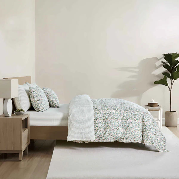 Teryn duvet cover set folded flat showing floral pattern in green, aqua, olive and white