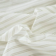 Close-up of Vale Green duvet cover fabric showing yarn-dyed green pinstripe pattern on cotton percale